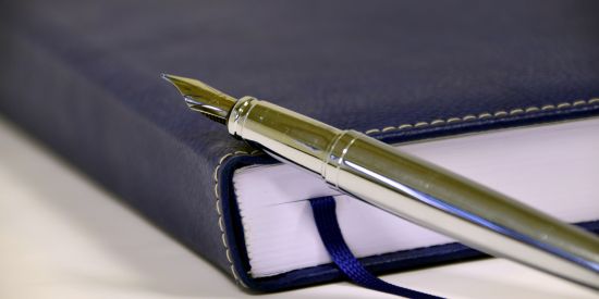 Leather bound writing book with silver fountain pen