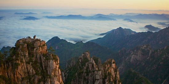 beautiful landscape with mountains peaking out of the clouds