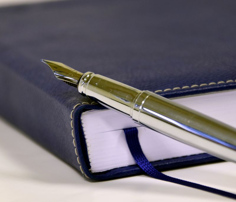 Leather bound writing book with silver fountain pen