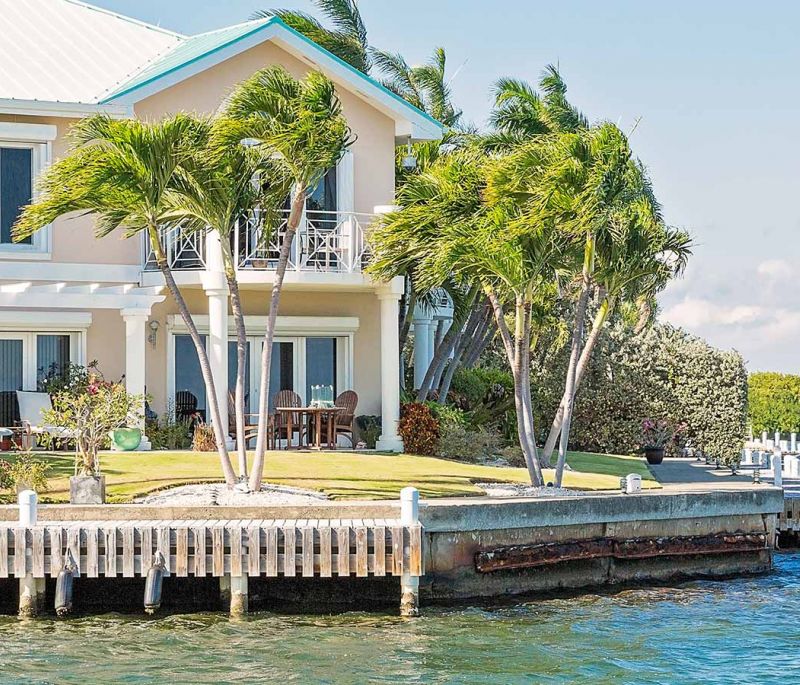 A property right by the water with palm trees