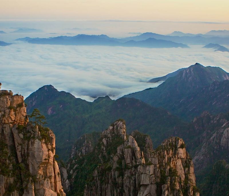 beautiful landscape with mountains peaking out of the clouds