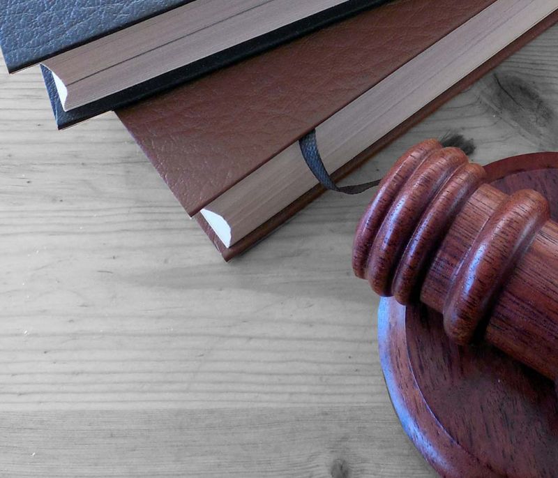 wooden gavel with burgundy and blue books